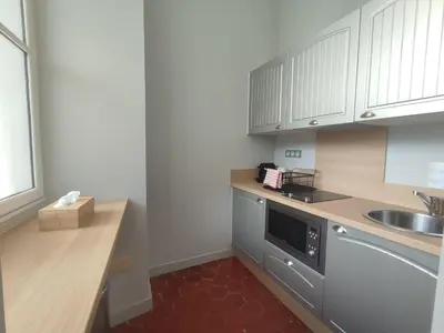 a small kitchen with white cabinets and a sink at La Redorte 4 in La Redorte