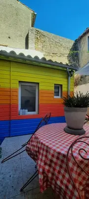 a table with a checkered table cloth in front of a building at One Hundred in Carcassonne