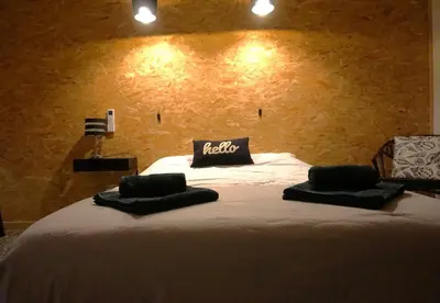 a bedroom with a bed with two pillows on it at One Hundred in Carcassonne