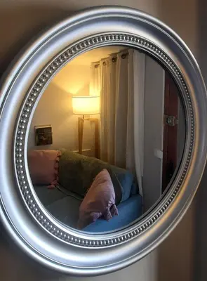 a mirror with a couch in a room at One Hundred in Carcassonne