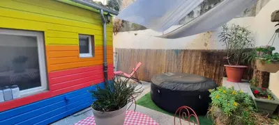 a colorful house with a patio with a tire at One Hundred in Carcassonne