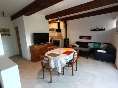 a living room with a table and a couch at Château de Prax Viel - piscine et mini ferme, climatisé in Lagrasse