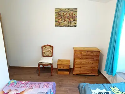 a bedroom with a dresser and a chair and a bed at Château de Prax Viel - piscine et mini ferme, climatisé in Lagrasse