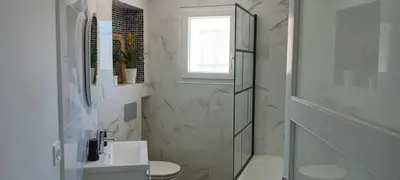 a bathroom with a sink and a toilet and a window at Chez Jacques in Port-la-Nouvelle
