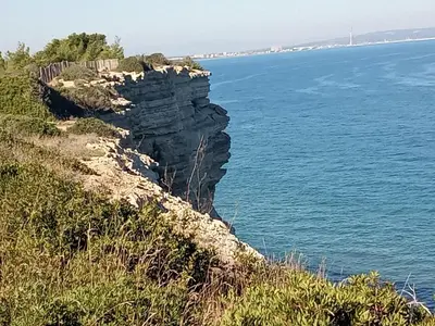 a cliff next to the ocean with a fence at Chez Jacques in Port-la-Nouvelle