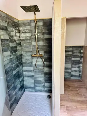 a bathroom with a shower with a shower head at Villa avec piscine chauffée et jacuzzi in Ouveillan