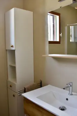 a bathroom with a sink and a mirror at Villa avec piscine chauffée et jacuzzi in Ouveillan
