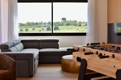 a living room with a couch and a table at Villa avec piscine chauffée et jacuzzi in Ouveillan