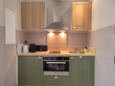 a kitchen with green cabinets and a sink at LA REDORTE Studio 15 in La Redorte