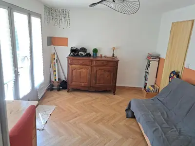 a living room with a couch and a wooden floor at Villa avec piscine à Montolieu in Montolieu