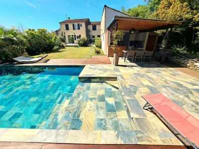 a swimming pool in front of a house at Villa avec piscine à Montolieu in Montolieu