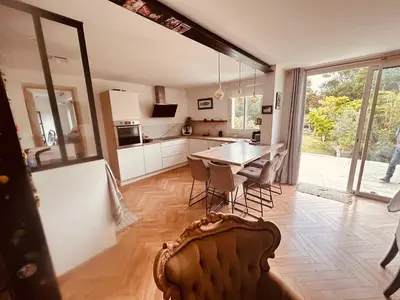 a kitchen and dining room with a table and chairs at Villa avec piscine à Montolieu in Montolieu