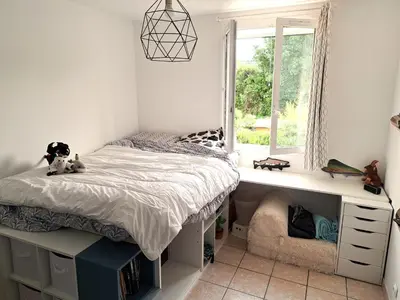 a bedroom with a bed and a window at Villa avec piscine à Montolieu in Montolieu