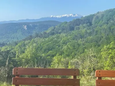 a wooden bench sitting on top of a mountain at Tiny House en bois in Cubières-sur-Cinoble