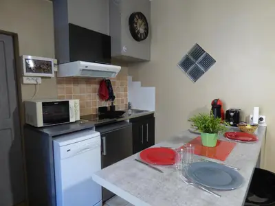 a kitchen with a counter top with a microwave at Chez Odile in Sigean