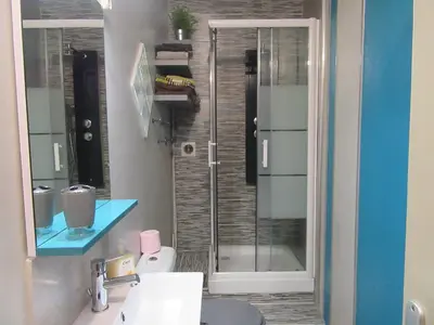 a bathroom with a shower with a glass door at Chez Odile in Sigean