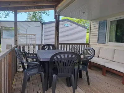 a patio with a table and chairs on a deck at Lya in Nages