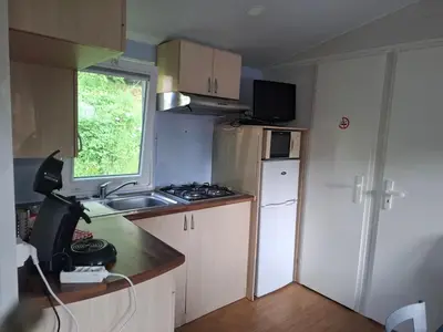 a small kitchen with a sink and a refrigerator at Lya in Nages