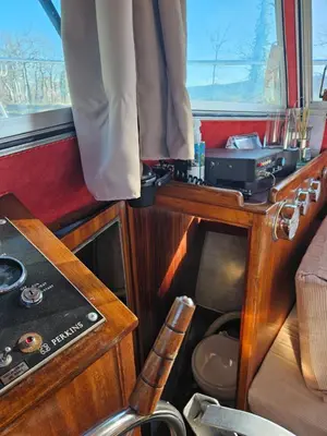 a small room with a table and a chair at bateau tinkerbell in Labastide-dʼAnjou