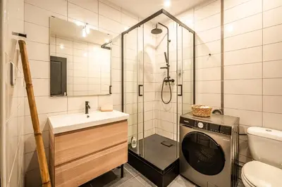 a bathroom with a washing machine and a sink at L'Appart Central - Chic et Confort in Narbonne