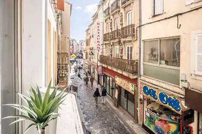 a group of people walking down a street with buildings at L'Appart Central - Chic et Confort in Narbonne