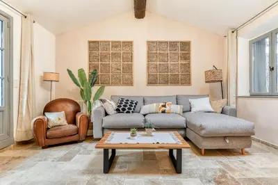 a living room with a couch and a table at Au Pied de la Cité - Terrasse - Climatisation - Wifi in Carcassonne