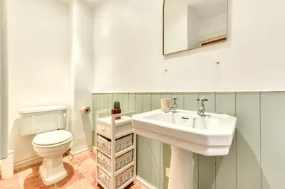 a bathroom with a sink and a toilet at Au Pied de la Cité - Terrasse - Climatisation - Wifi in Carcassonne