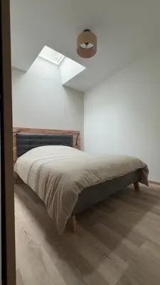 a bedroom with a bed with a ceiling fan at Le petit narbonnais in Narbonne