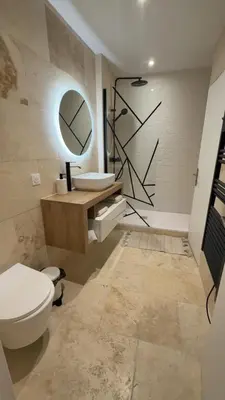 a bathroom with a toilet and a sink and a mirror at Le petit narbonnais in Narbonne