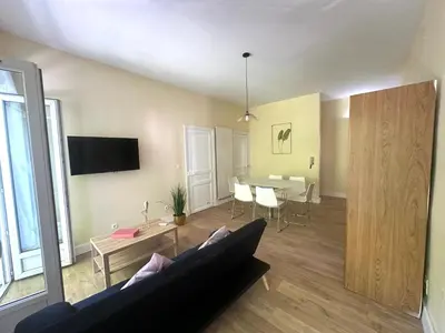 a living room with a couch and a table at Centre ville, grand T3 avec balcon in Narbonne