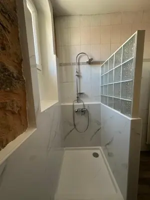 a bathroom with a shower and a tub with a sink at Centre ville, grand T3 avec balcon in Narbonne