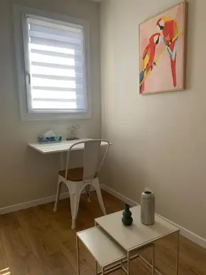 a room with a desk and a chair and a table at Superbe Appartement T2 climatisé in Gruissan