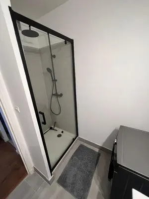 a bathroom with a shower with a glass door at Casa Colori - Charmant T2 in Carcassonne