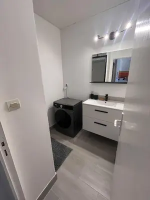 a white bathroom with a sink and a mirror at Casa Colori - Charmant T2 in Carcassonne