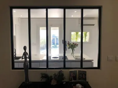 a room with a window with a statue in front of it at Les Oliviers in Villemoustaussou