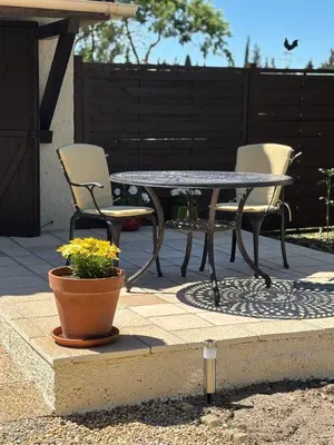 a patio table and chairs and a potted plant at The Studio at Gites 474 in Sallèles-dʼAude