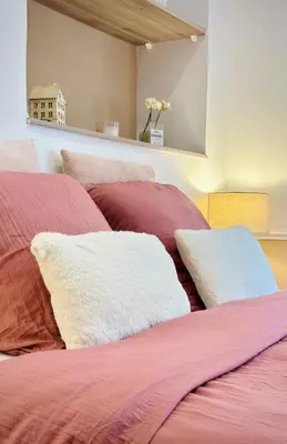 a bed with red and white pillows in a room at Puddington Abbey by Art&Suites Élégant XVIIIe 80m privatif Centre ville Calme et douceur de vivre in Narbonne