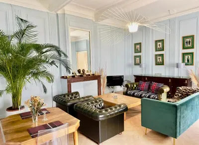 a living room with a couch and a table at Puddington Abbey by Art&Suites Élégant XVIIIe 80m privatif Centre ville Calme et douceur de vivre in Narbonne