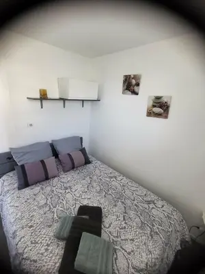 a stuffed teddy bear laying on a bed at Cocon du Lac 4 couchages 500m à pied des plages in Port-la-Nouvelle