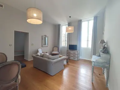 a living room with a couch and a chair at Suite de Rêve au Château avec Bain Caché - Accès Bassin de Nage - Clim in La Redorte