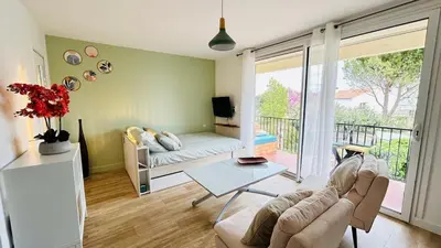 a living room with a couch and a table at Studio Chanzy lumineux cozy avec terrasse Narbonne in Narbonne