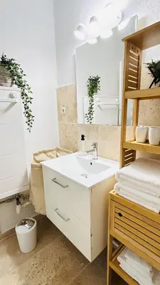 a bathroom with a white sink and a mirror at Studio Chanzy lumineux cozy avec terrasse Narbonne in Narbonne