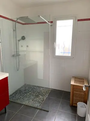 a shower with a glass door in a bathroom at Villa Alfabeta in Bizanet