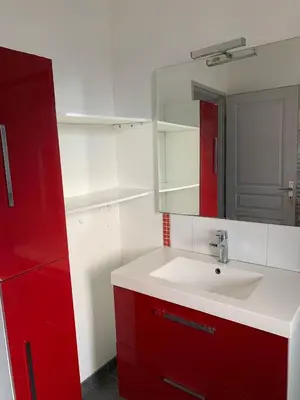 a bathroom with a sink and a red cabinet at Villa Alfabeta in Bizanet