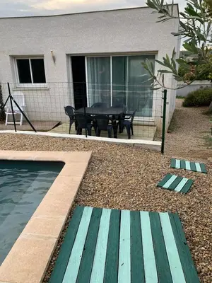a house with a pool and a picnic table in the backyard at Villa Alfabeta in Bizanet