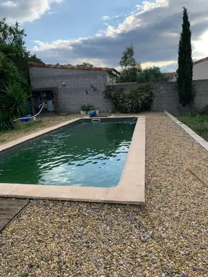 a swimming pool in a yard with a house at Villa Alfabeta in Bizanet