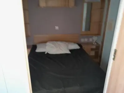 a small bedroom with a bed in a room at Mobilhome tout confort in Port-la-Nouvelle