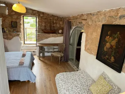 a bedroom with a bed and a table in a room at Chateau Fitou Presbytery in Fitou