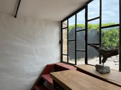 a room with a table and a large window at Chateau Fitou Presbytery in Fitou