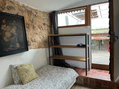 a bedroom with a bunk bed and a window at Chateau Fitou Presbytery in Fitou